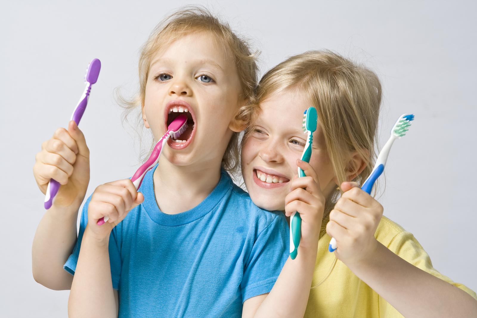 Photograph of laughing children with toothbrushes, Family Dentistry, Waterloo, ON